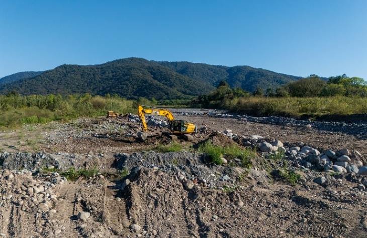 Maquinaria pesada trabajando en la Ruta Provincial 321 y el río Lules para recuperar la calzada y encauzar el río.